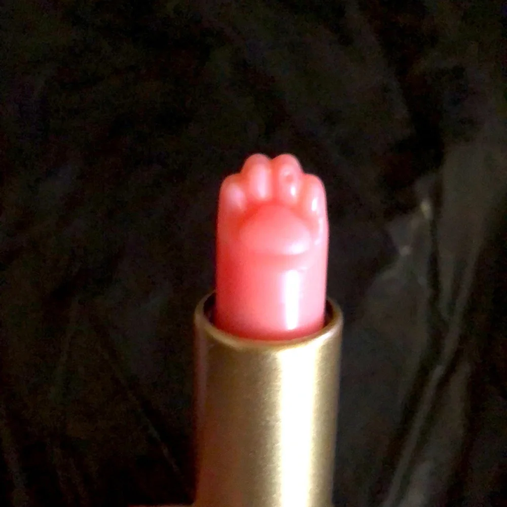 Ten peach-colored lip balms